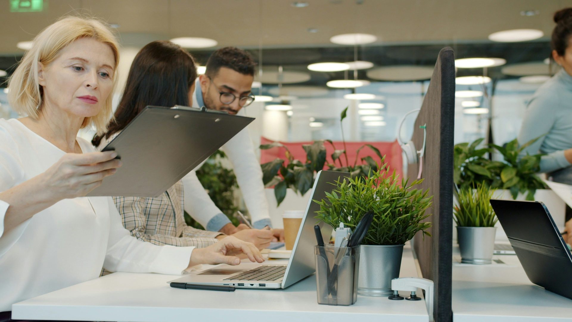 Colleagues collaborating in a modern office environment.